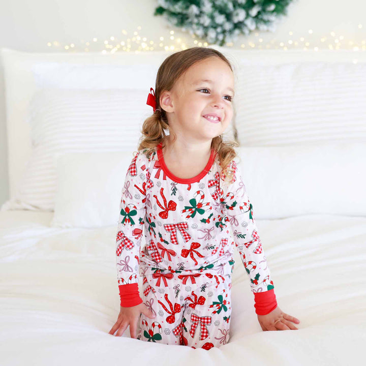 Little girl wearing the Bow What Fun Two Piece Pajama Set