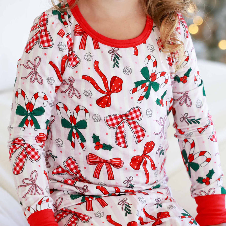 close up of Little girl wearing the Bow What Fun Two Piece Pajama Set