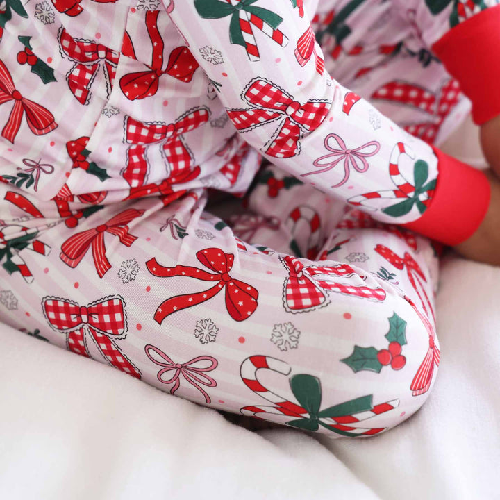 close up of the back of Little girl wearing the Bow What Fun Two Piece Pajama Set