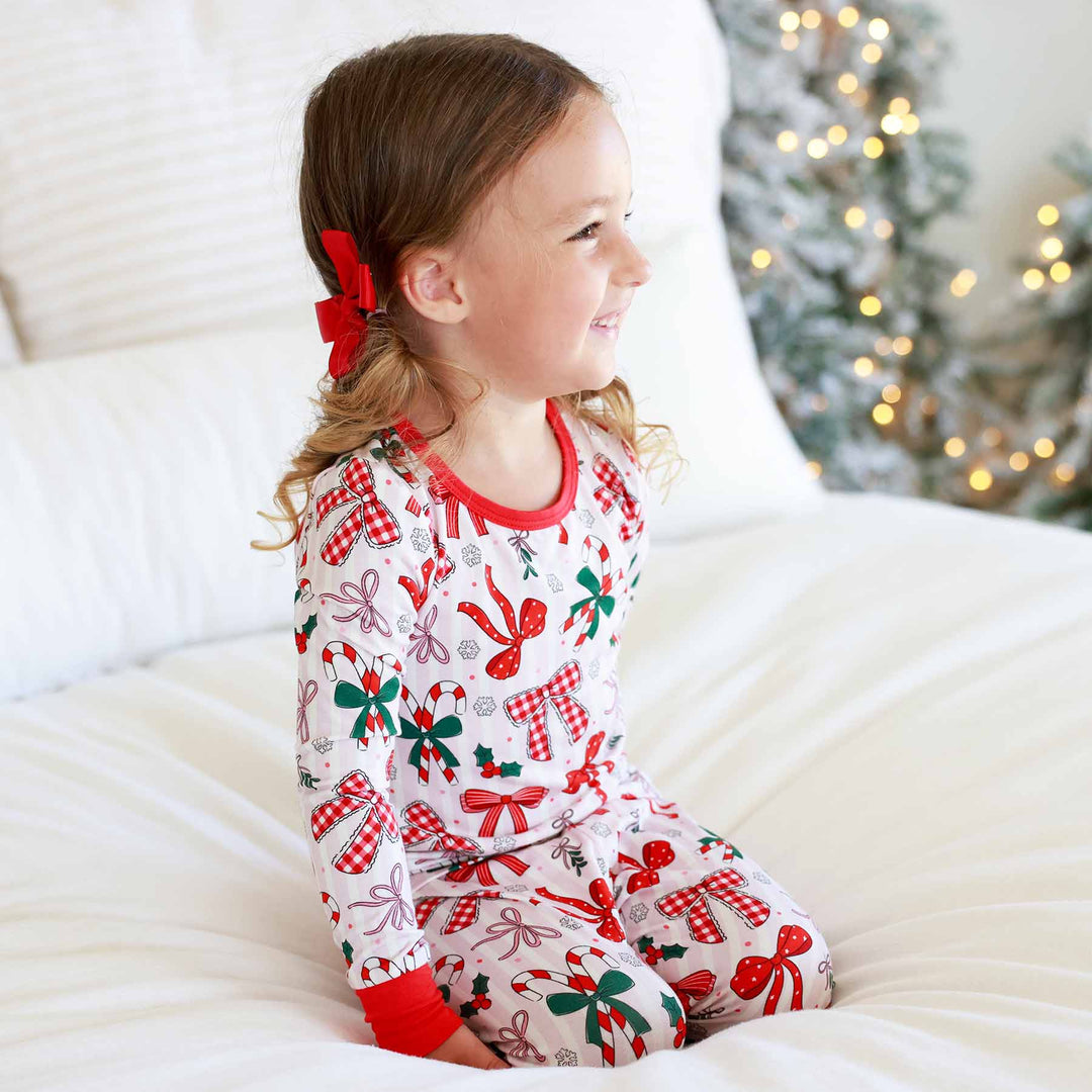 Little girl wearing the Bow What Fun Two Piece Pajama Set