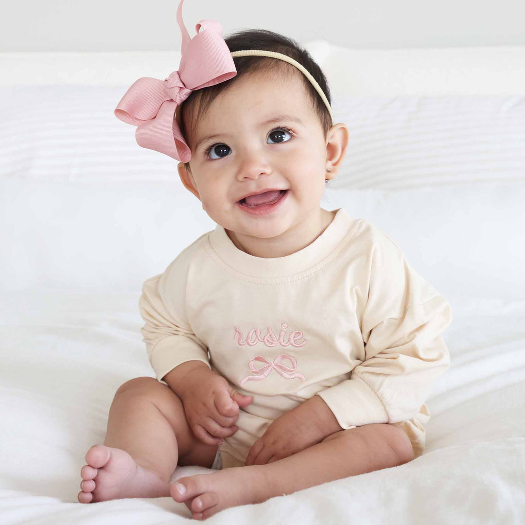 long sleeve bubble romper with name and bow embroidered light pink thread 