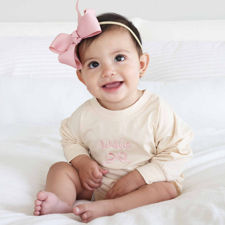 long sleeve bubble romper with name and bow embroidered light pink thread 