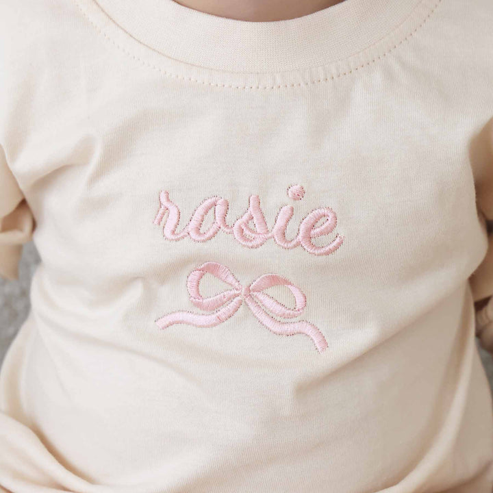 bow embroidered romper light pink thread 