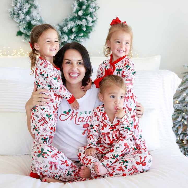Little girl on the left wearing the Bow What Fun Two Piece Pajama Set. Little girl on the right wearing the Bow What Fun Two Piece Flare Lounge Set. All matching mom in the center. 