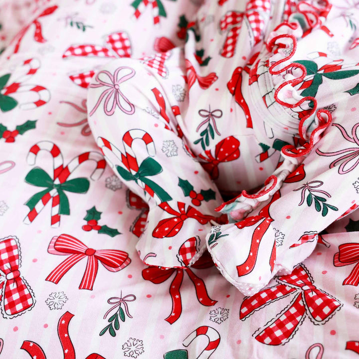 Close up of Baby wearing the Bow What Fun Ruffle Zipper Footie