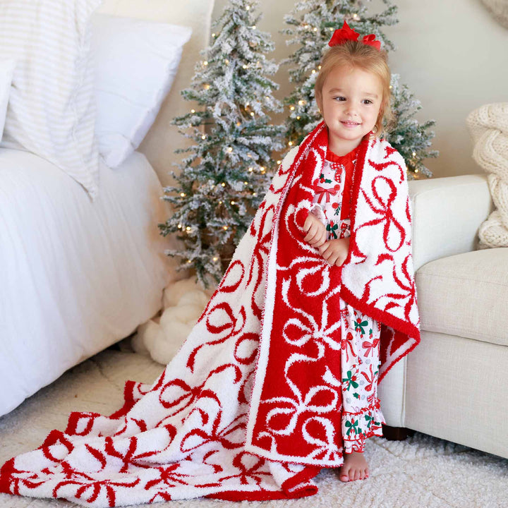 girl wrapped in a bow microfiber blanket for christmas 