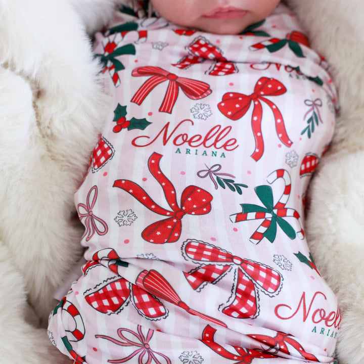 christmas bow personalized swaddle blanket with red bows, candy canes and holly berries