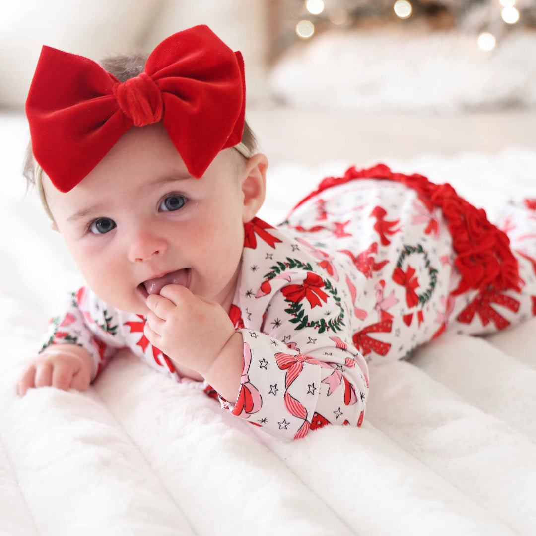 christmas ruffle zipper footie for girls with bows and wreaths 