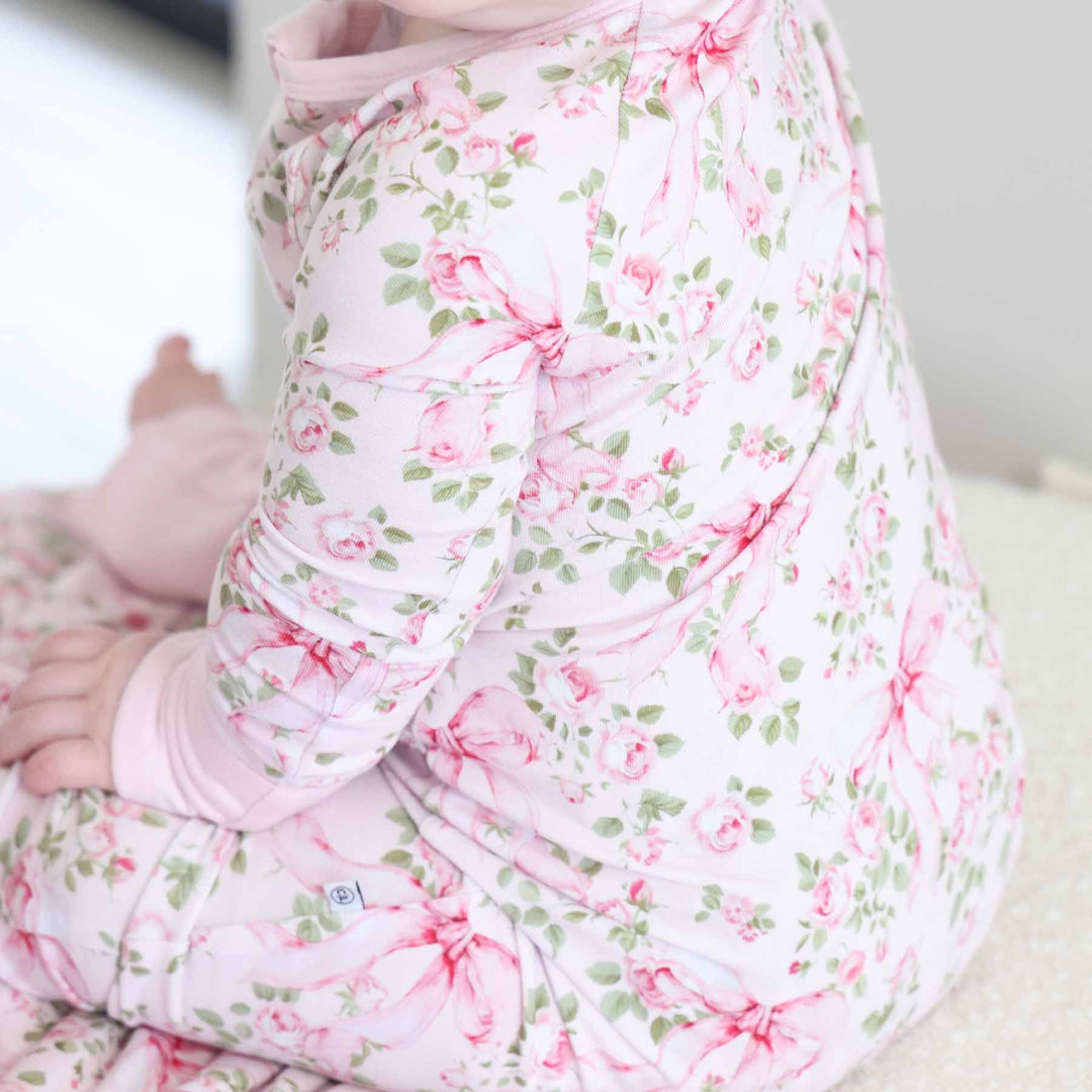pink and green floral and bow zip romper pajama for babies and toddlers 