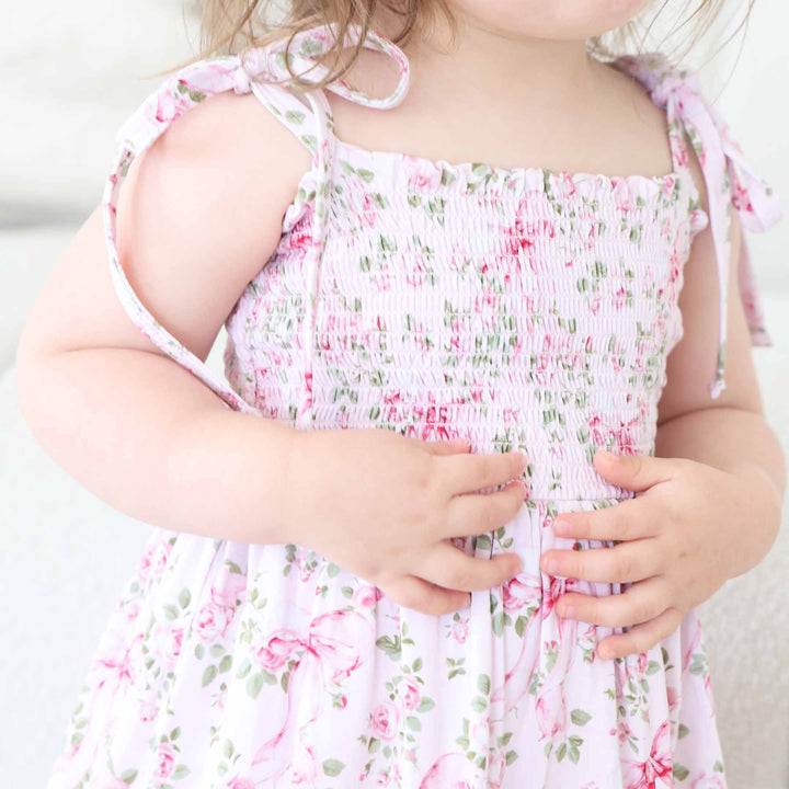 pink floral and bow smocked bodysuit for girls 