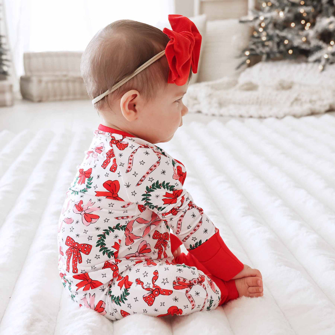 baby christmas pajamas with wreaths and bows 