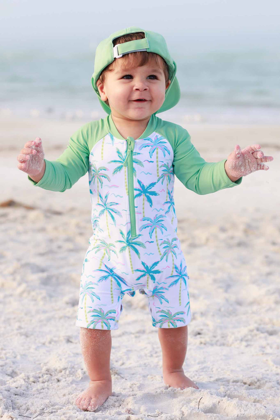 blue lagoon shortie romper with tropical green surf hat 