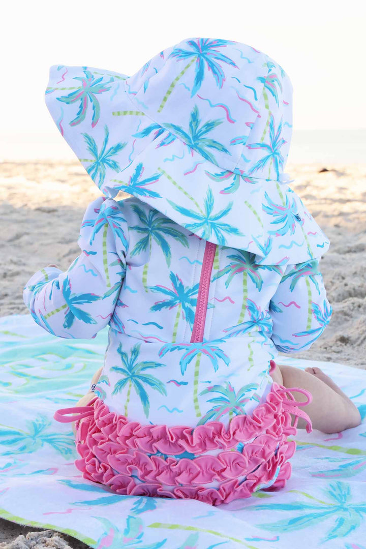 back view of blue lagoon upf 50+ sun hat palm trees