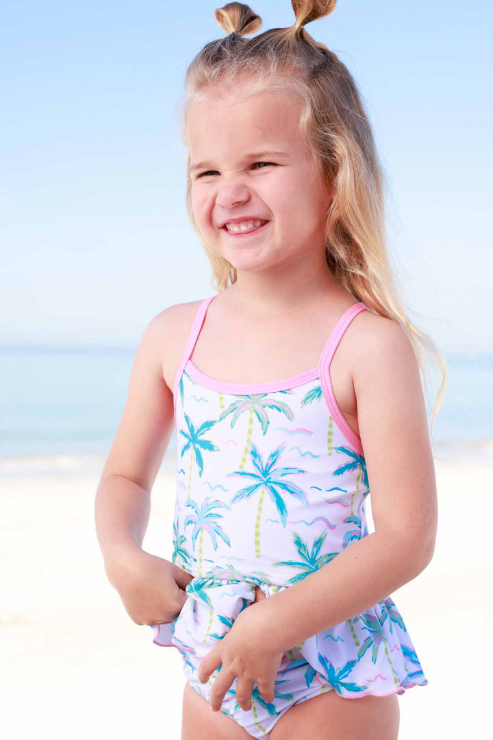 girl at beach in blue lagoon tankini with space buns 