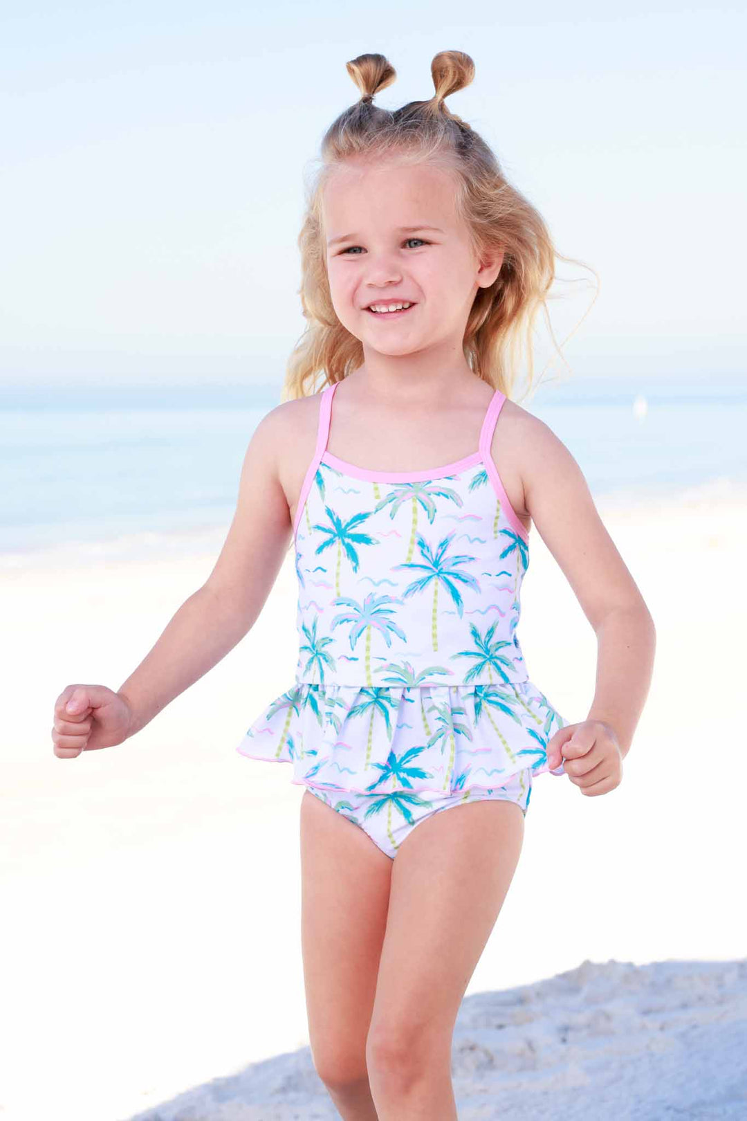 girl running on beach in neon palm treen tankini 