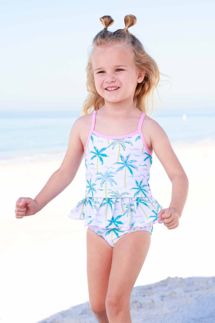 girl running on beach in neon palm treen tankini 