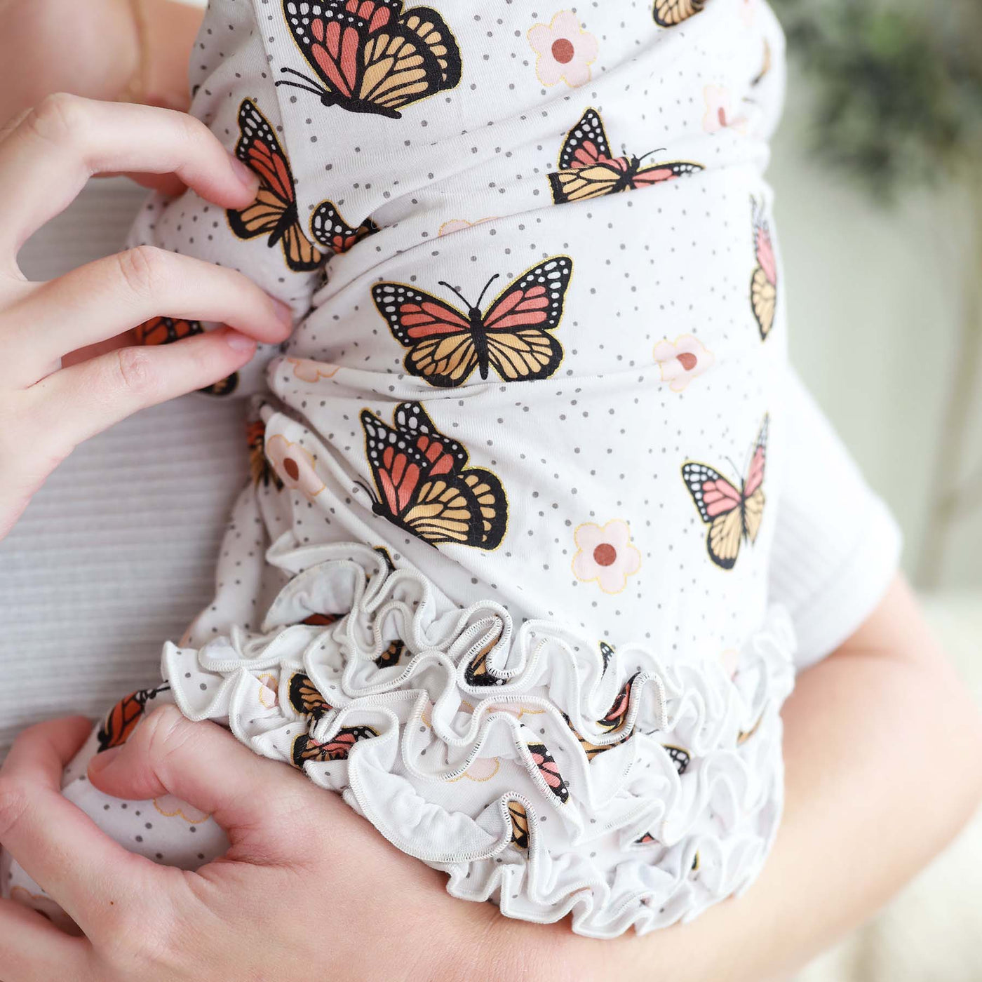 gold foil butterfly baby footie with ruffles on butt 