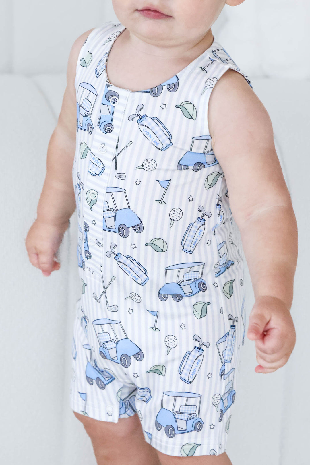 closeup of caddie crew blue snap romper