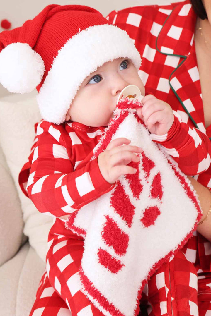 white lovey with a red trim and red candy cane reversible design for christmas