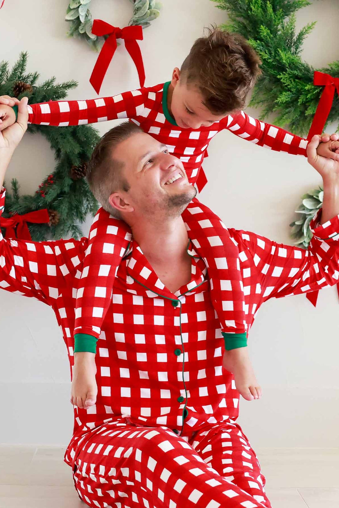Father and son in red, green, and white plaid Caden Lane pajamas