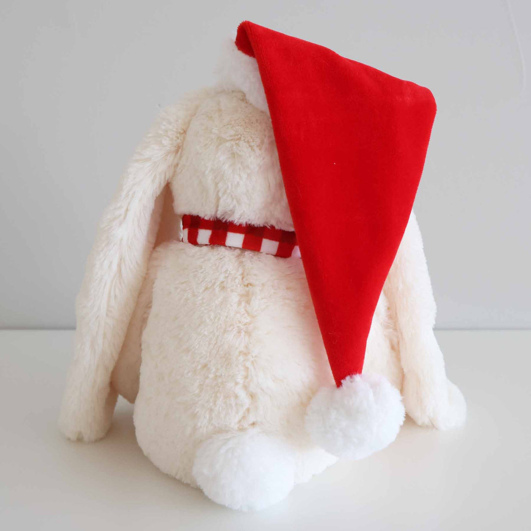 back view of christmas bunny stuffed animal with red hat and red and white checkered scarf