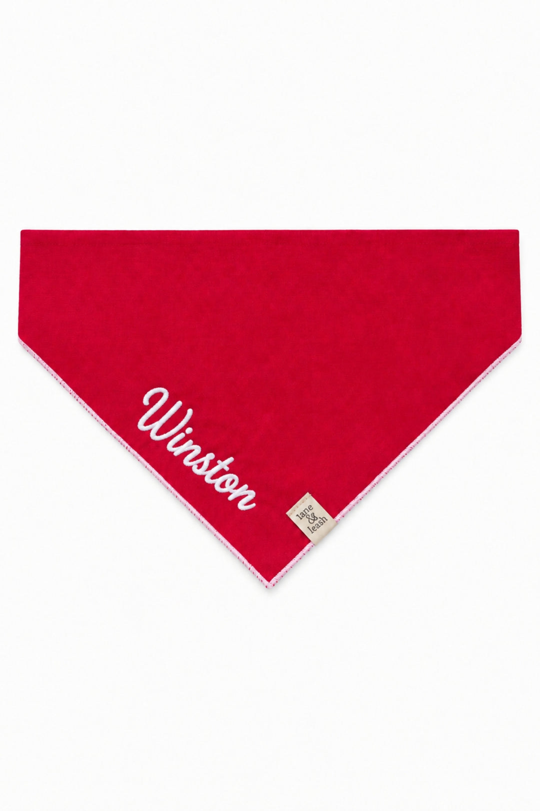 Lane & Leash personalized dog bandana in solid red with white stitched edging, embroidered with the name 'Winston' in white script