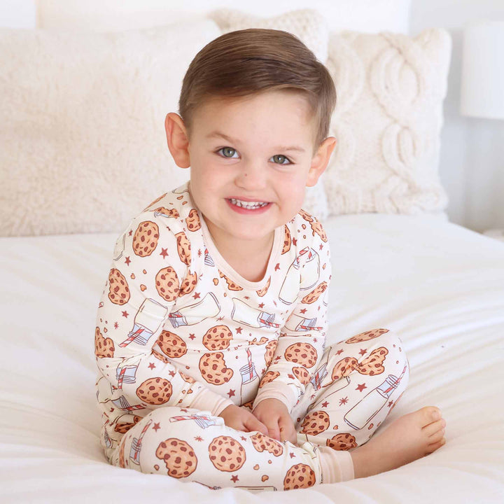 boy wearing neutral colored milk and cookies two piece pajama set 
