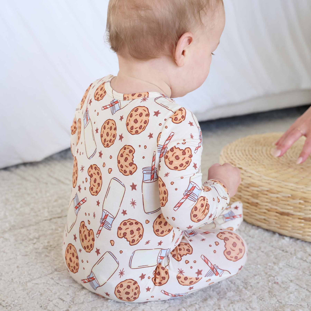 beige footie with cookies and milk in jar with striped straw