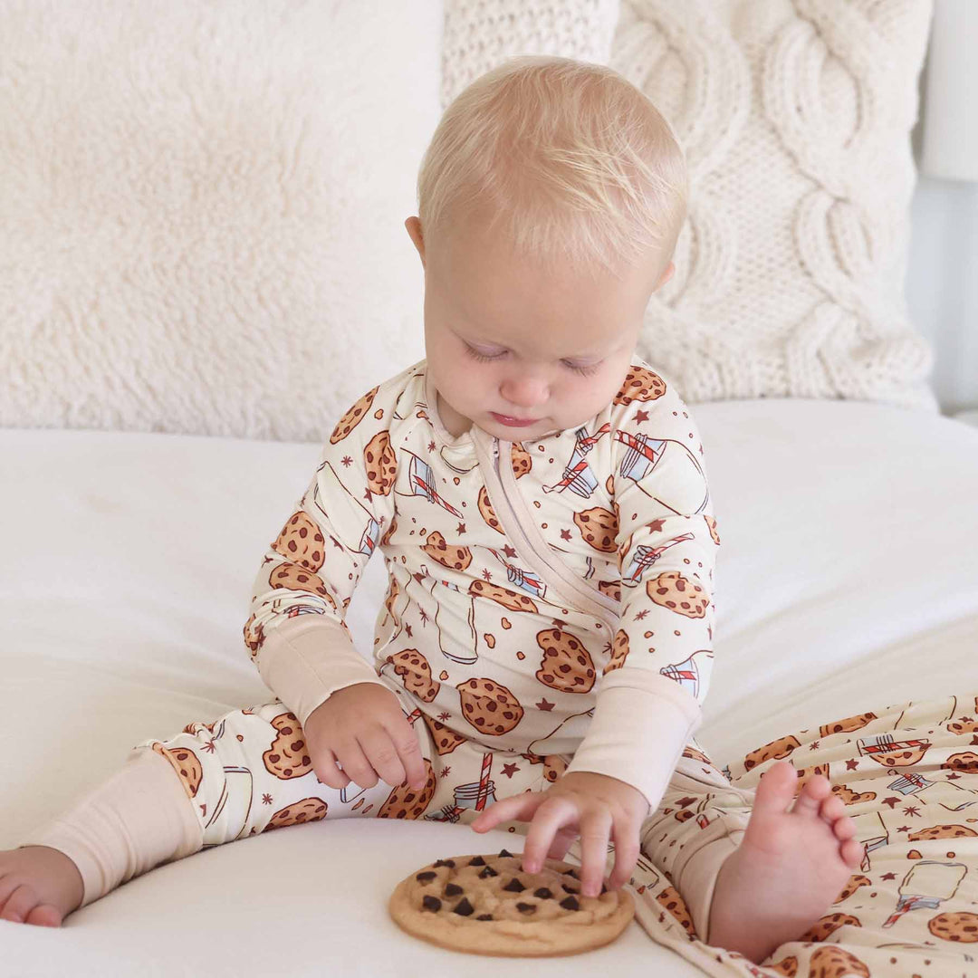Baby sitting with cookie toy wearing Cookie Cuddles Convertible Zip Romper