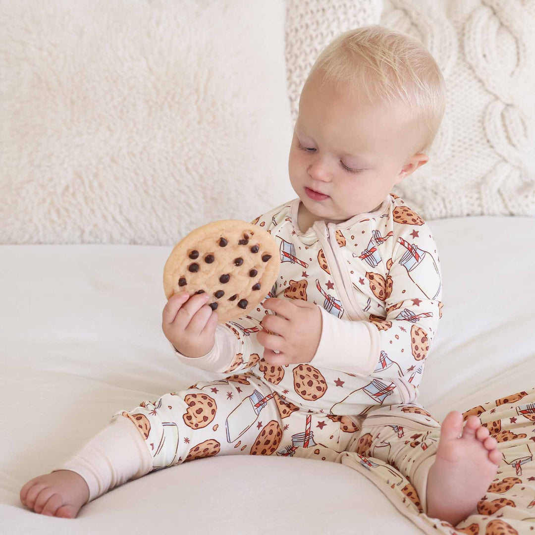 Baby sitting with cookie toy wearing Cookie Cuddles Convertible Zip Romper