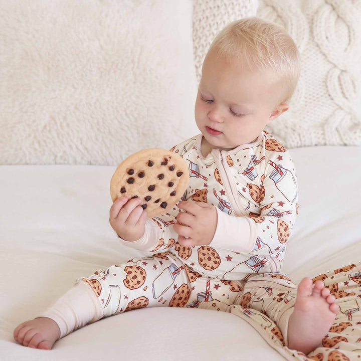 Baby sitting with cookie toy wearing Cookie Cuddles Convertible Zip Romper