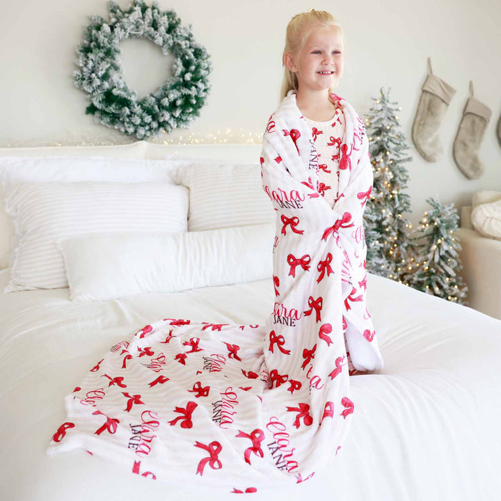 kids personalized blanket with pink and white stripes and red bows 