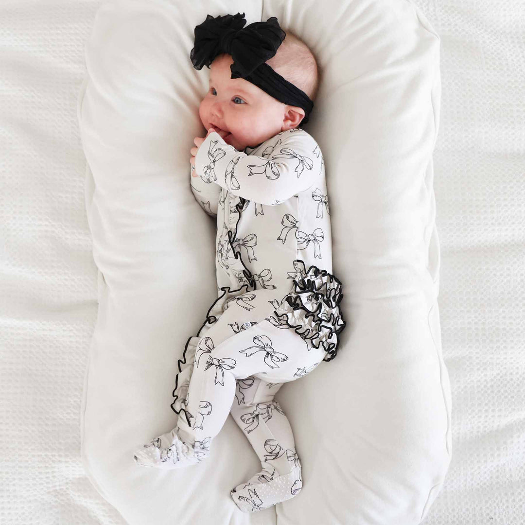 neutral bow ruffle footie for babies black and white