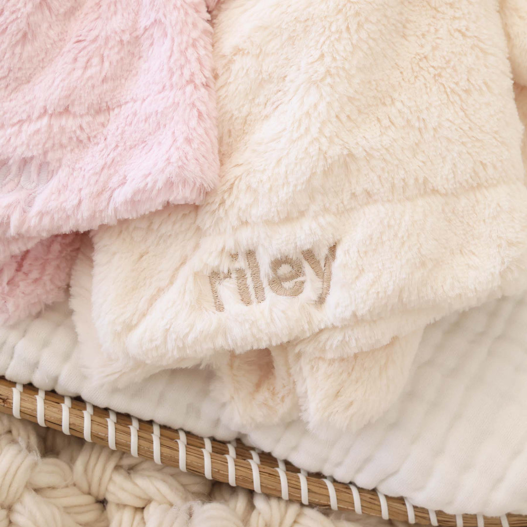 closeup of plush bunny lovies in pink and white that can be embroidered with the baby's name 