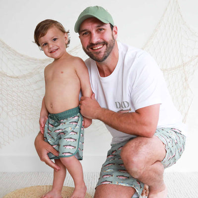 dad and son matching swimsuits with trout 
