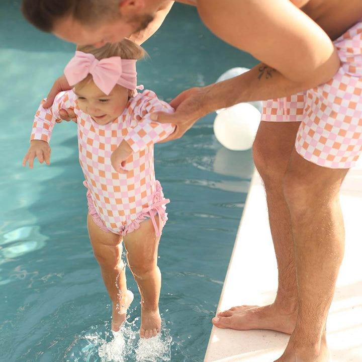 pink and orange checkered men's swim trunks 