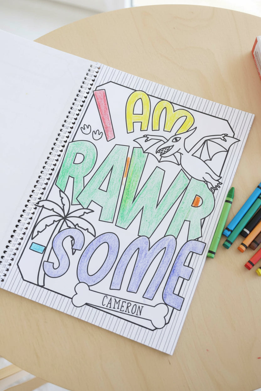 Personalized 'I Am Rawrsome, Cameron' page from a Caden Lane Dinosaur Coloring Book, colored in with red, yellow, green, and blue crayon, featuring a pterodactyl illustration