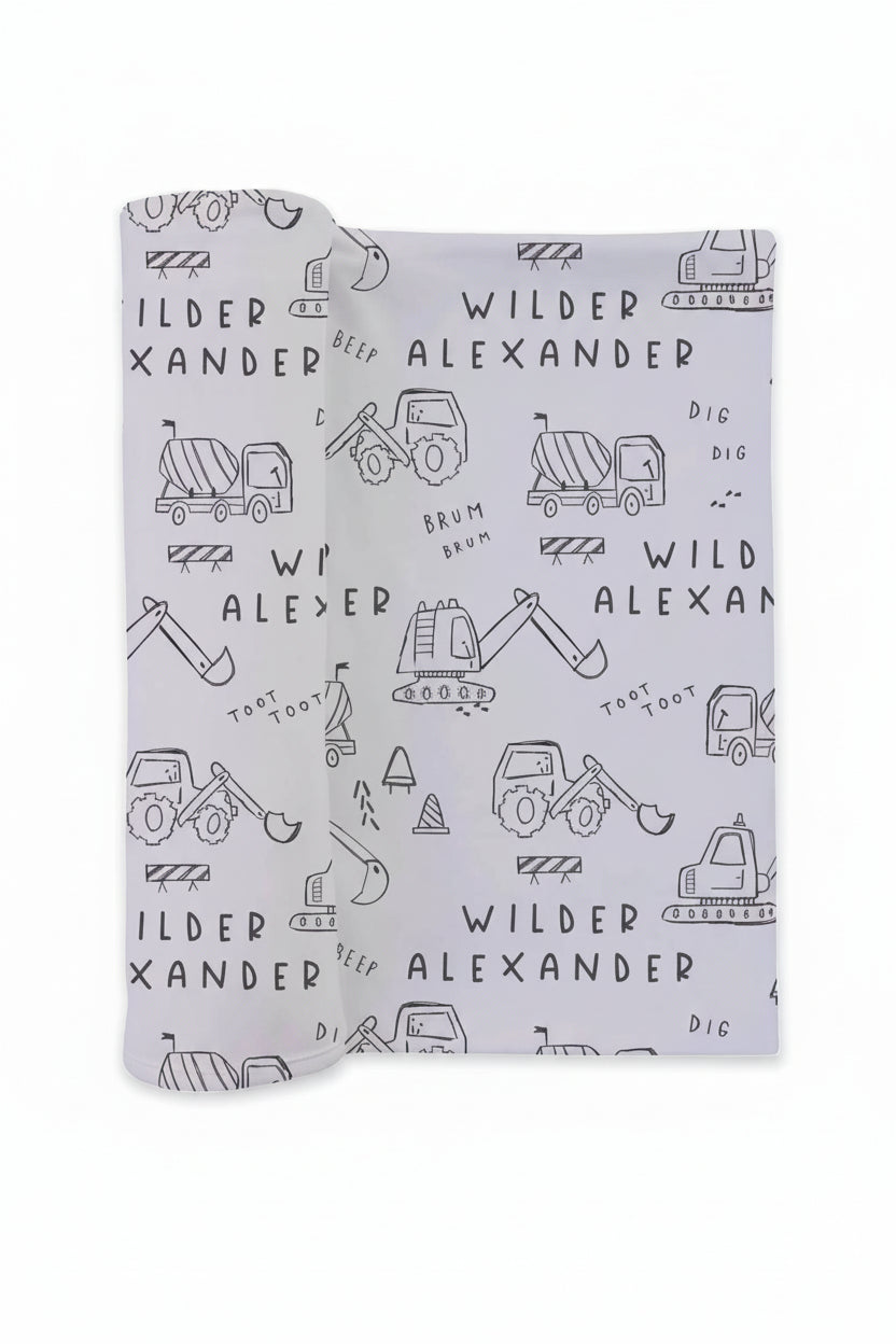 personalized swaddle in doodle print of trucks and dozers for newborn baby boys