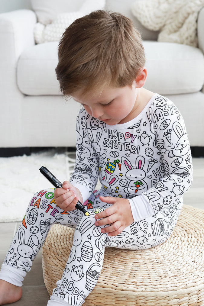 kid with fabric marker coloring easter themed colorable pajamas