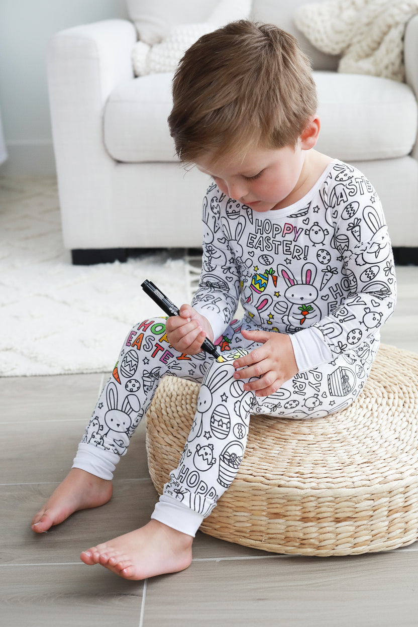 kid with fabric marker coloring easter themed colorable pajamas