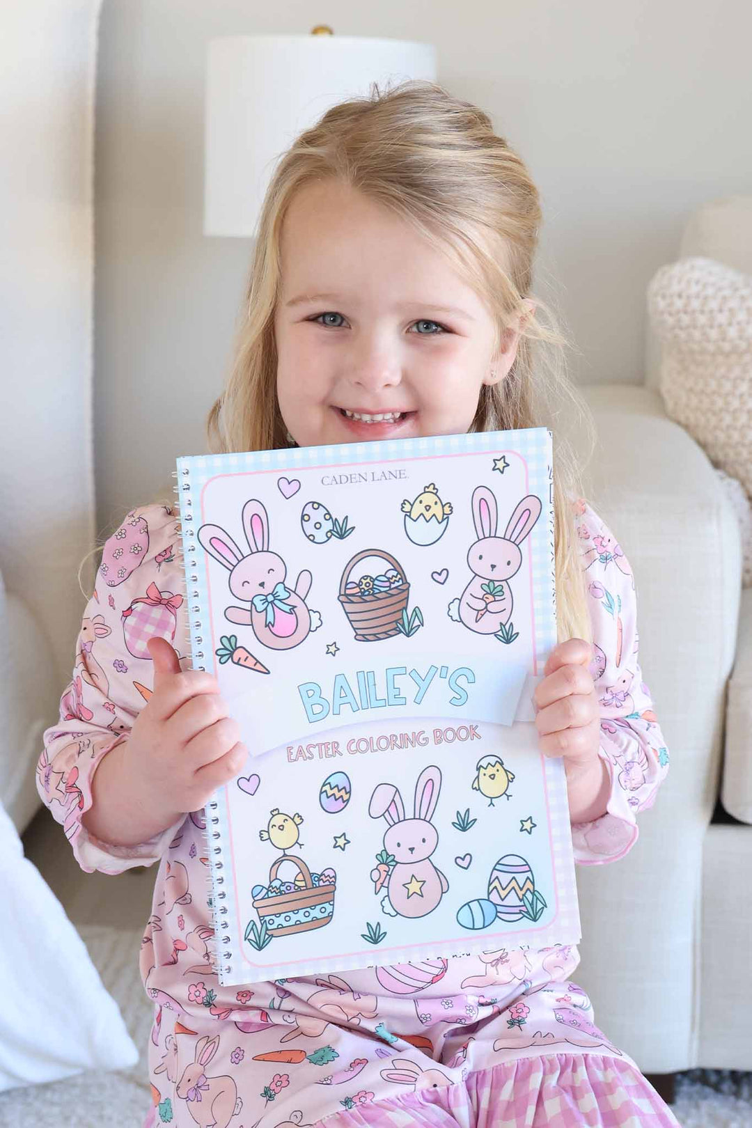 girl holding personalized easter coloring book 