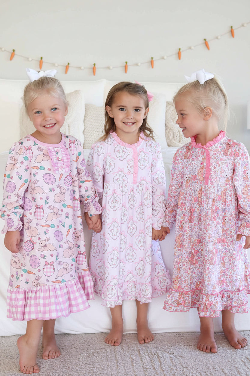 three girls holding hands wearing long sleeve easter nightgowns 