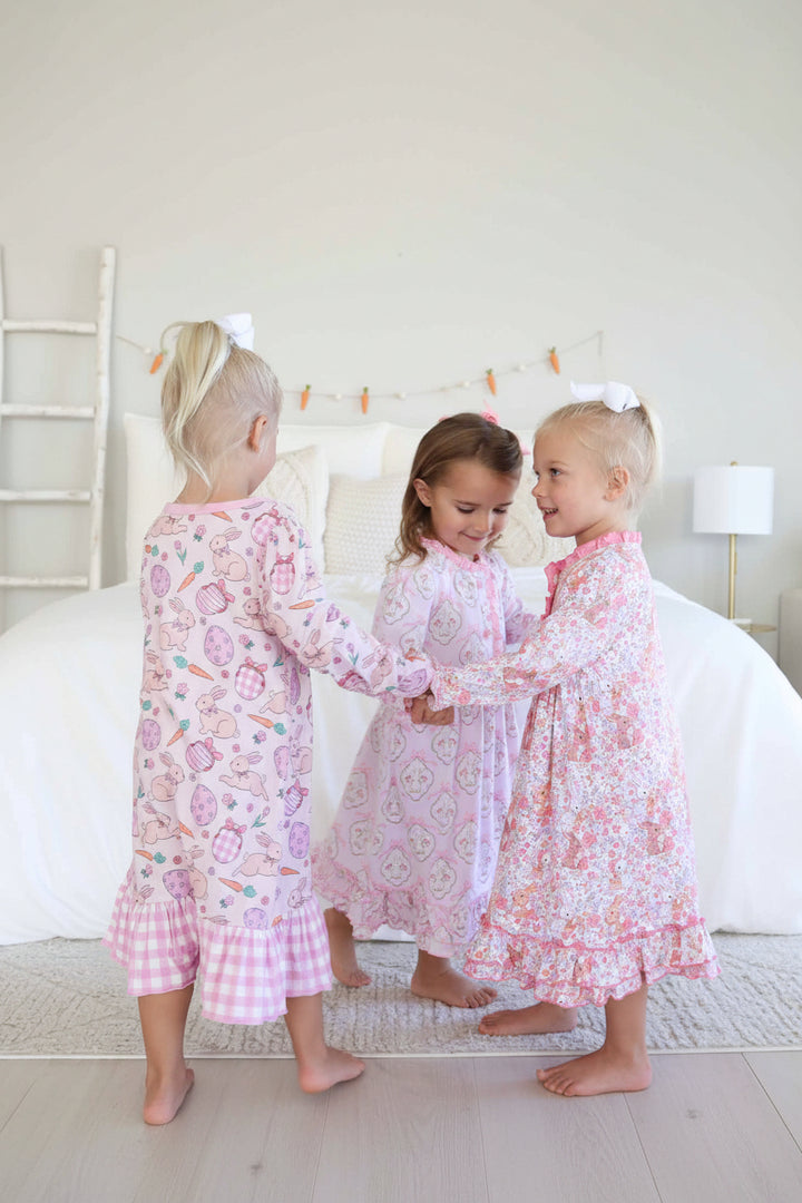 girls twirling in a circle wearing long sleeve midi length easter nightgowns 