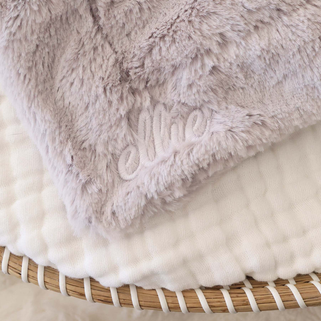 closeup of grey elephant lovey with white thread script font name 