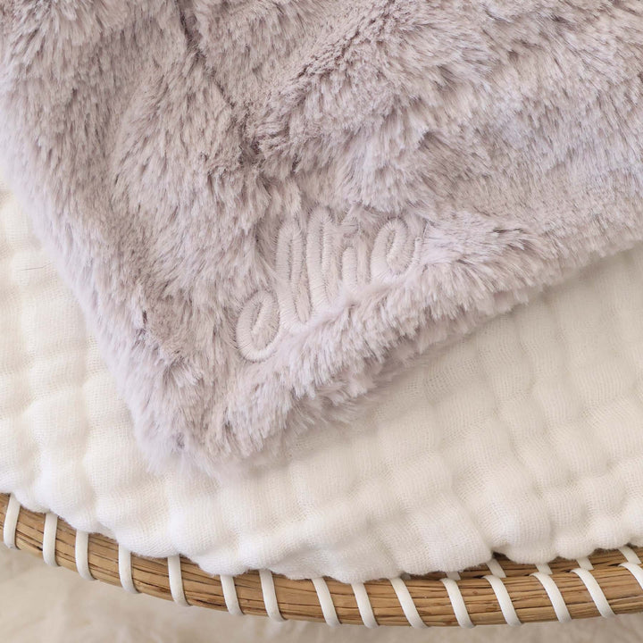 closeup of grey elephant lovey with white thread script font name 