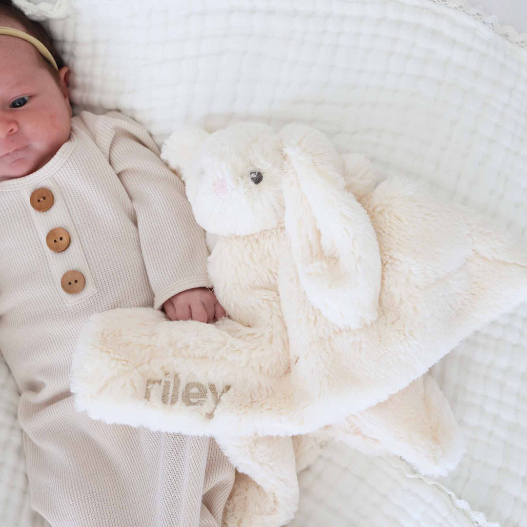 white stuffed animal bunny lovey for babies embroidered with name in beige thread and block font 