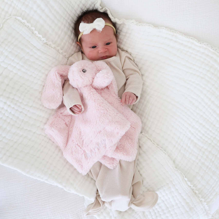 light pink embroidered bunny lovey for baby girls with name in white thread and script font 