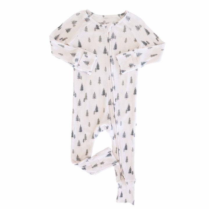 flat lay of evergreen controvertible zip romper. Green pine trees with white background 