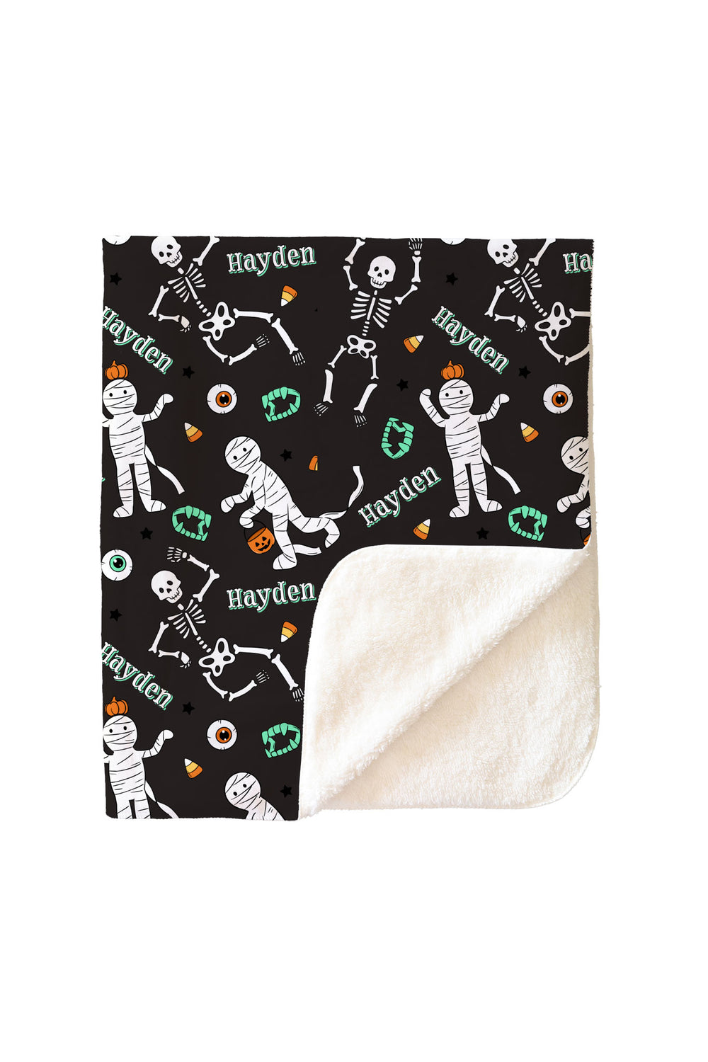 Halloween-themed blanket with skeletons, mummies, and candy patterns on a black background.