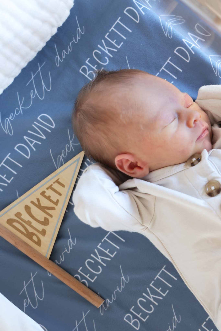 closeup of personalized flag wood sign for newborn boys 